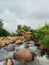 Spring summer potrait blue sky clouds river stone green trees