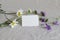 Spring, summer still life composition. Closeup of blank business, place card cotton paper mockup with wild flowers on
