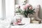 Spring, summer wedding still life scene. Blank paper card mockup, old books and linen pillow at windowsill. Vintage