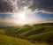 Spring sunset over green hills