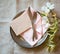 Spring Table Place Setting with dogwood flowers, light pink napkin, silverware and a blank card for menu or invitation.