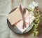 Spring Table Place Setting with dogwood flowers, pink napkin, silverware and a blank card for menu or invitation.