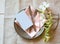 Spring Table Place Setting with white flowers, pink napkin, silverware and a blank card for party menu or invitation.