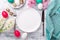 Spring table setting. Green mint plate, easter eggs, hyacinth and silver cutlery on wooden background