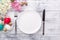 Spring table setting. Green mint plate, easter eggs, hyacinth and silver cutlery on wooden background