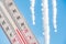 In the spring, the thermometer is on the background of melting icicles and shows a negative temperature.Meteorological conditions,