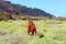 Spring time hike. Back view of girl exploring the northern of the island of Lanzarote. Young female backpacker walking in wild