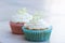 Spring time muffins with elder-flower topping in a blue and pink paper muffin liners