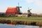 Spring trip to Zaanse Schans. Placid channels, tranquil rivers flow between the hills. The Dutch windmills stand as a traditional