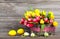 Spring tulips in wooden basket with Easter eggs