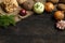 Spring vegetables on a dark background: onion, garlic, kohlrabi, celery root, dill, beets, potatoes