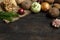 Spring vegetables on a dark background: onion, garlic, kohlrabi, celery root, dill, beets, potatoes