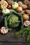 Spring vegetables on a dark background: Savoy cabbage, cauliflower, onion, garlic, kohlrabi, celery root, dill