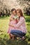 Spring vertical portrait of happy mother and kid daughter