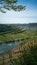 Spring view of Moselle River valley,Germany,Europe,from Moseltal bridge viewpoint.Sunny vertical landscape,vineyards