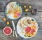 Spring vitamin breakfast set. Thin crepes or pancakes with fresh grapefruit, orange, kumquat, honey, cream and mint leaves over a