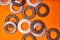 Spring washers on orange background. Bolted connection elements