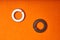 Spring washers on orange background. Bolted connection elements