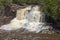 Spring Waters on a Waterfall amidst Red Rocks