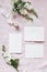 Spring, wedding stationery mockup scene. Bouquet of baby`s breath Gypsophila and matthiola flowers on pink linen