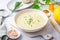 Spring white creamy zucchini soup with herbs