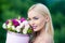 Spring woman with present flowers. Women`s day. Beauty day in spring. Flowers box for woman. Valentine Beauty blonde