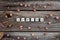 Spring word is made of bright wood cubes on a dark wooden background