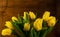 Spring yellow bouquet on wooden background