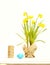 Spring yellow narcissus, blue easter egg and thread or rope