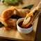 Springrolls, Pan-Asian rolls with sweet and sour sauce. Oriental dish and bamboo chopsticks on wooden table. Close up