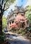 Springtime Charm: A Victorian House and a Parked Street Car in t