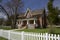 Springtime in the front lawn of the house with white picket fences