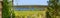 Springtime landscape, banner, panorama - view through the pines and birch on Desna river with flooded meadows and forests