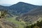 Springtime panorama of mountain landscape with forest and beauty meanders river in valley