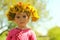 Springtime portrait of a cute two years old girl posing with a dandelion wreath