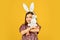 Springtime. small girl hold hare toy. happy childhood. cute child play with toy. toy shop concept. girl in funny rabbit