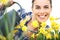 Springtime, smiling woman in garden with watering can