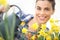 Springtime, smiling woman in garden with watering can, watering