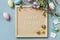 Springtime welcome concept. Letter Board Quote HAPPY EASTER in letter board Easter eggs and green branches on a blue background,