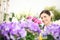 Springtime, woman smiling with white wicker basket flowers