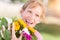 Springy Outdoor Portrait of an Excited Young Adult Brown Eyed Woman Hold