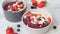 Sprinkle with coconut chips smoothie bowl with granola, berries and coconut. Healthy vegan food concept.