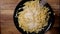 Sprinkle Parmesan cheese over a plate of pasta - slow motion