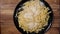 Sprinkle Parmesan cheese over a plate of pasta - slow motion