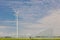 Sprinkler on farmland in front of a wind park with wind turbines in Flevoland, The Netherlands