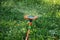 Sprinkler head in blurred motion. Sprinkler splashing water all around