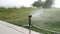 Sprinkler Irrigation System. Morning watering lawns