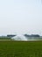 sprinkler system growing irrigation pond rural meadow Netherlands Holland