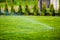 Sprinkler System Moisturizing Green Grass And Shrubs