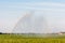 A sprinkler is watering farmland in the Netherlands